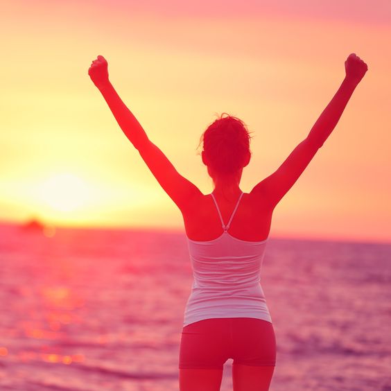 Life achievement - happy woman arms up in success becoming your best self