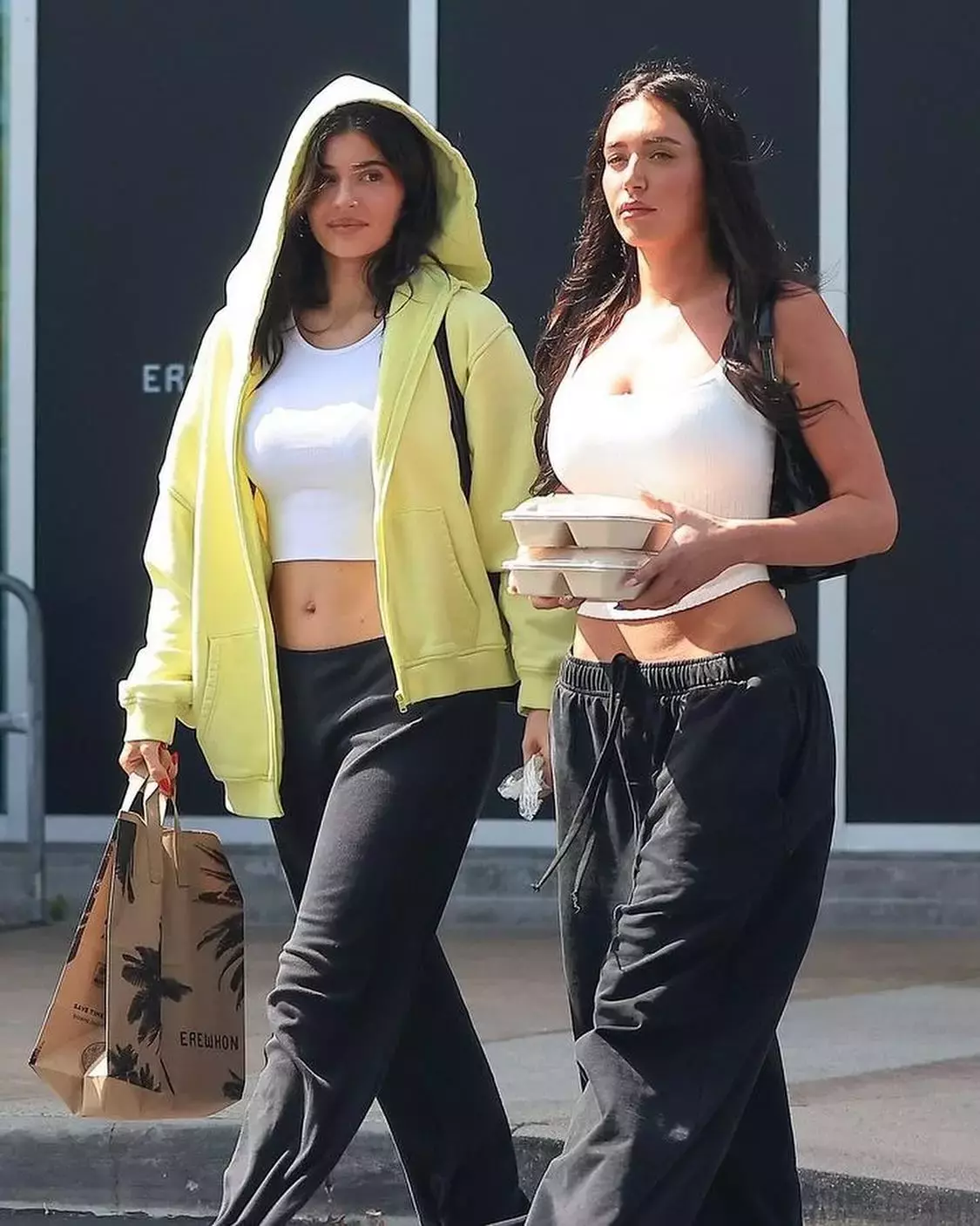 Kylie Jenner wearing Khy Fleece Straight Leg Pant Khy Cropped Raw Hem Rib Tank Salomon Xt Slate Sneakers and Khy Fleece Oversized Zip Hoodie 1