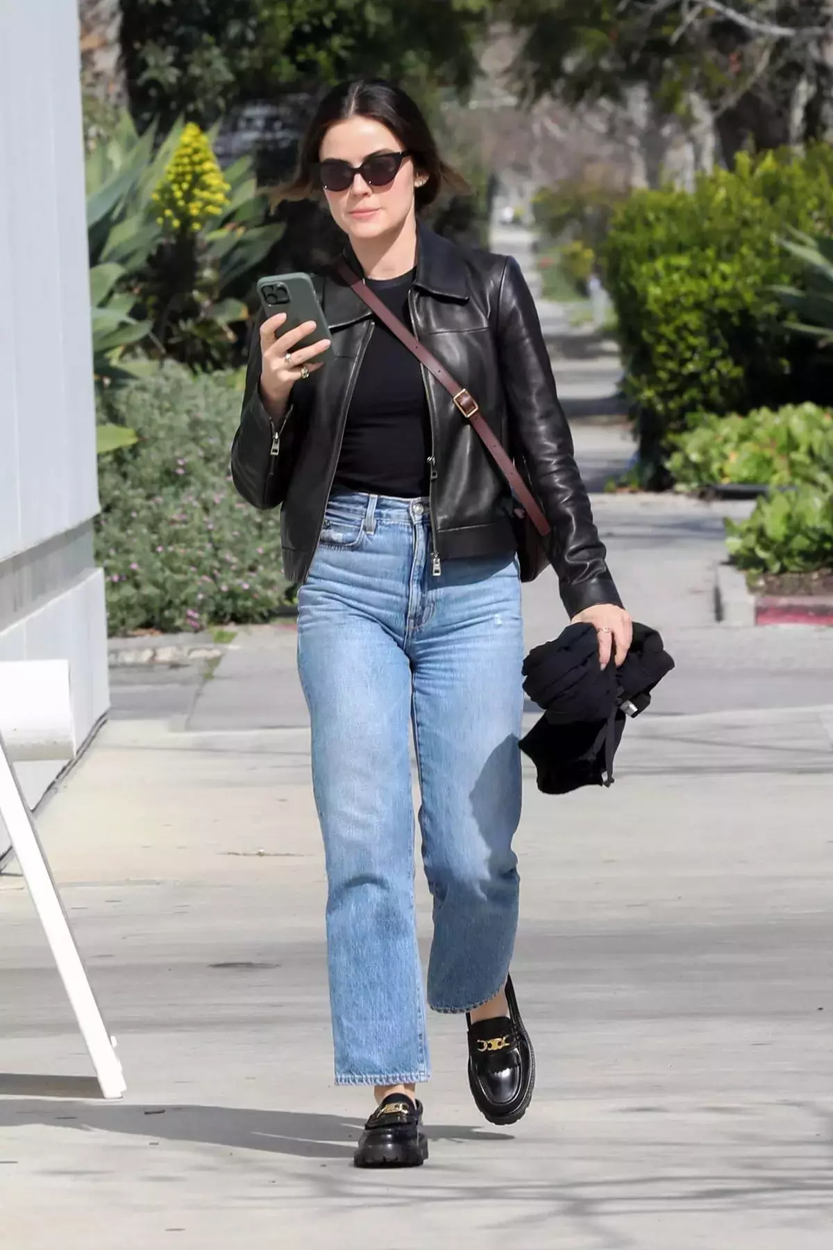 Lucy Hale rocks a leather jacket and jeans while grabbing some lunch to go at Catch Steak in West Hollywood California
