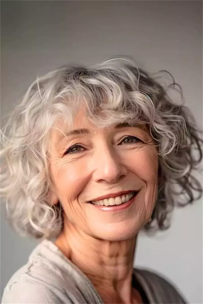 woman over 60 short soft silver curls 17