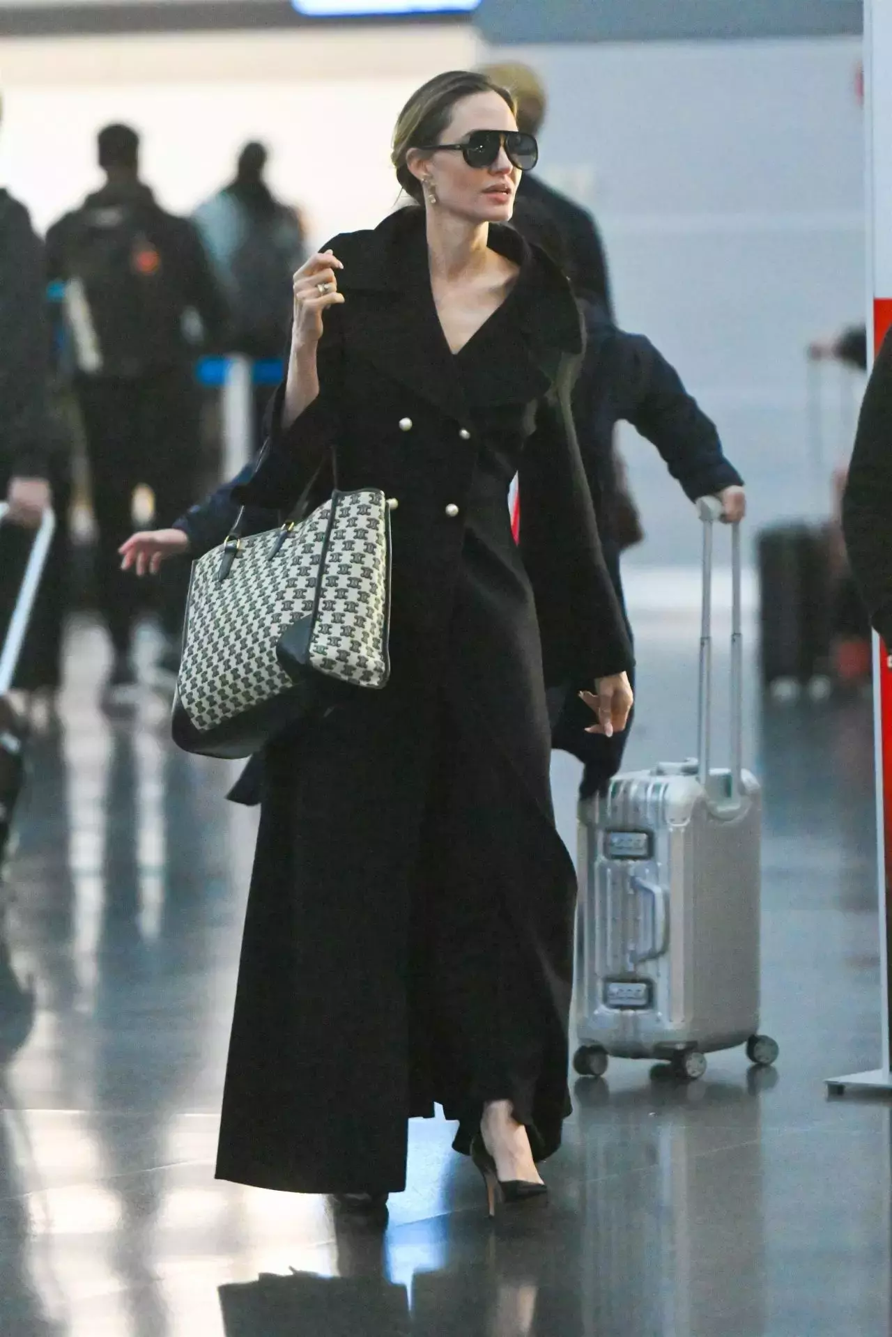 Angelina Jolie In A Chic Long Black Overcoat And Carrying A Dior Handbag At Jfk Airport In New York