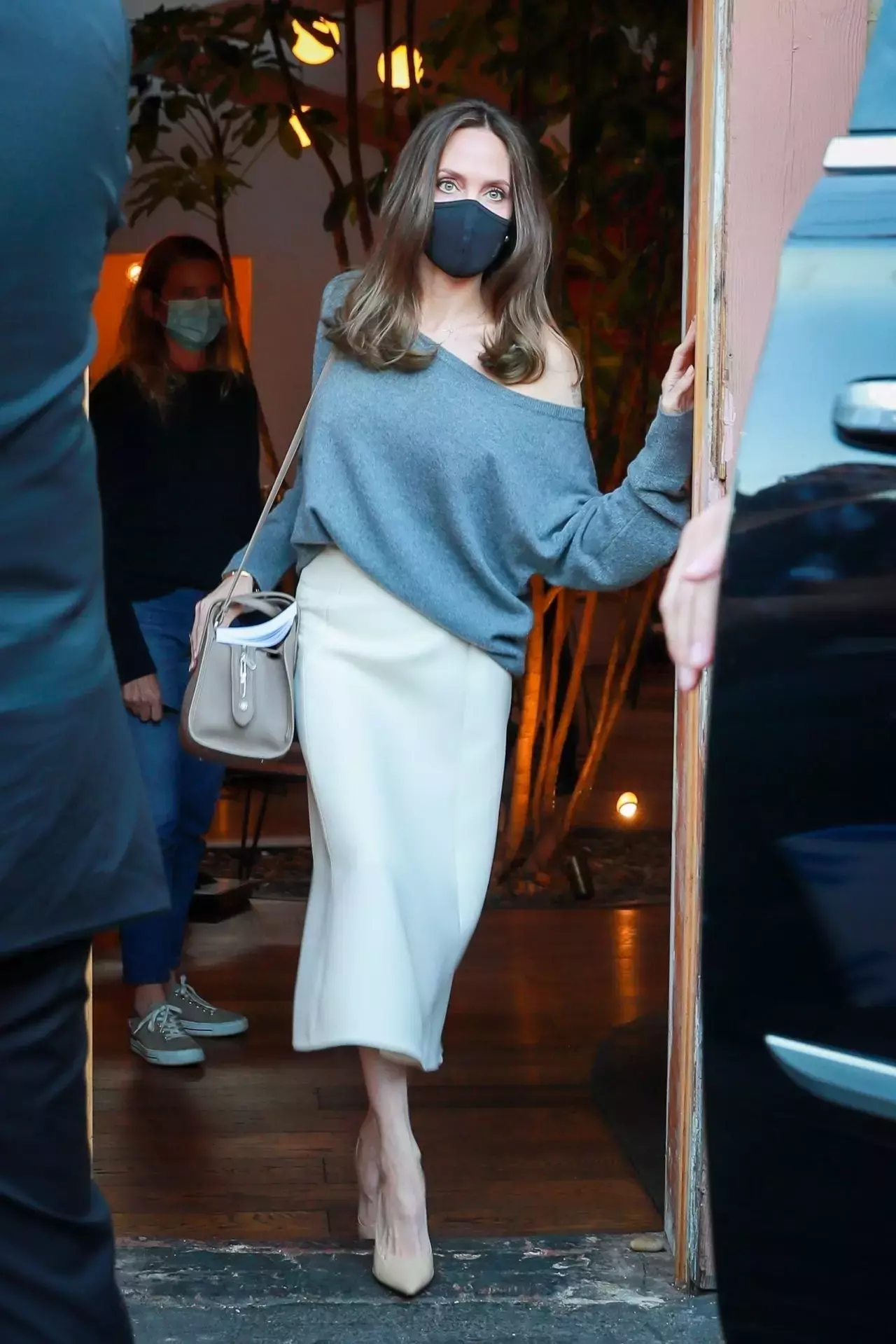 Angelina Jolie In An Off The Shoulder Grey Sweater And Flowing White Skirt Skylight Bookstore In La