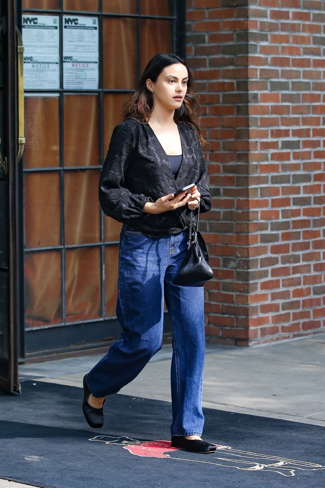 Camila Mendes In A Sleek Black Top And Classic Denim Jeans In New York