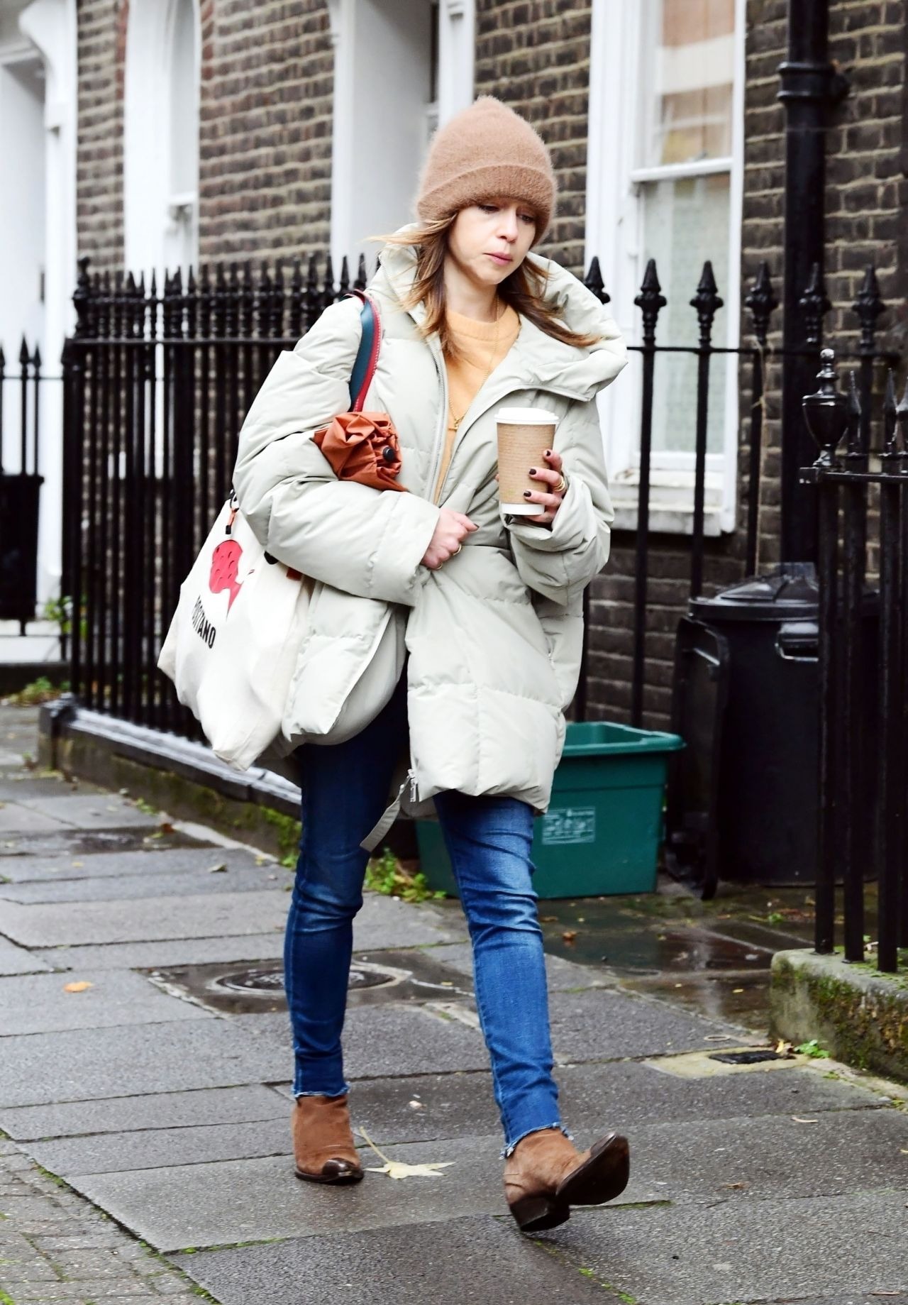 Emilia Clarke In An Oversized Puffer Jacket And Beanie Hat London