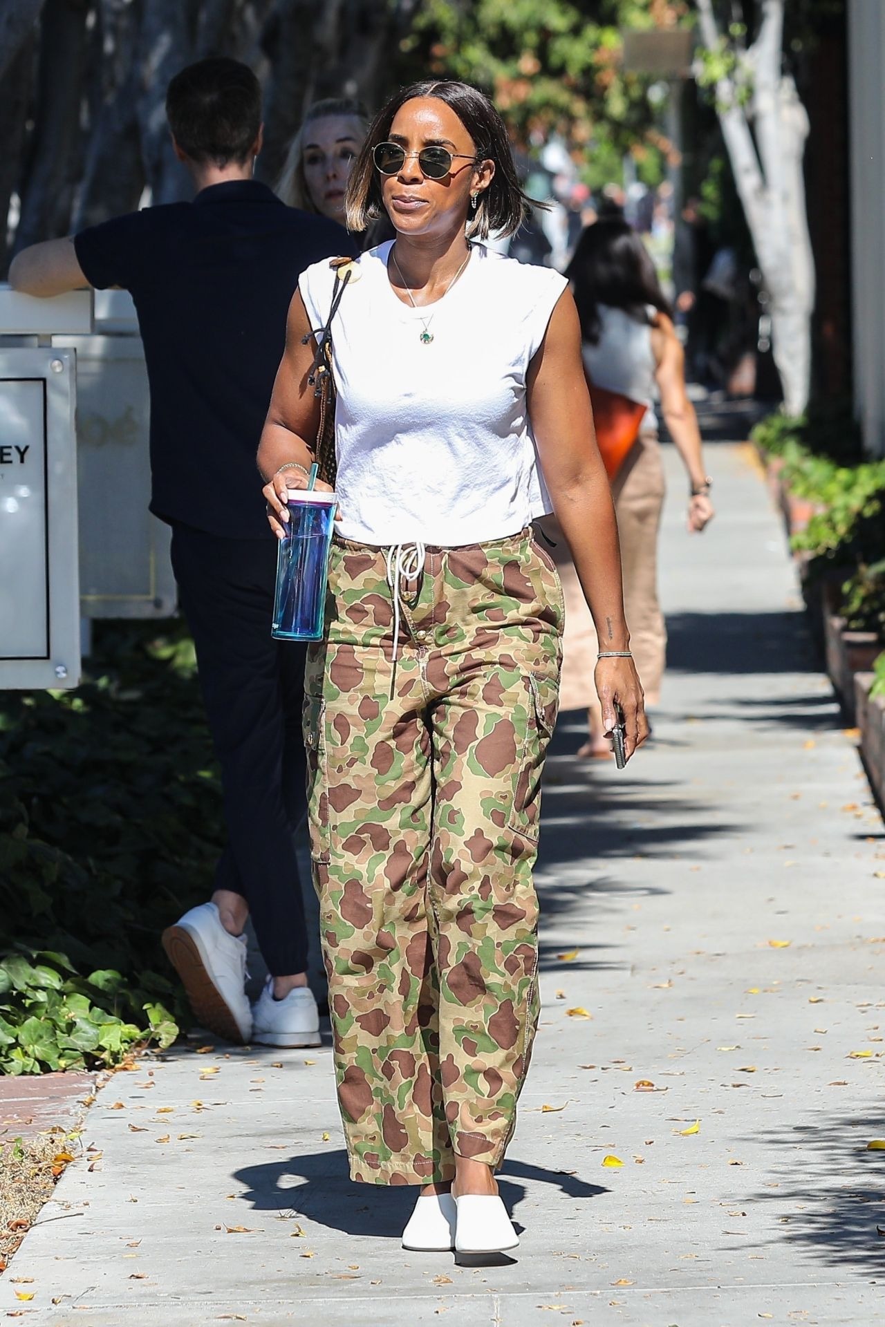 Kelly Rowland In Camouflaged Colored Pants White Top And White Sandals Shopping On Melrose In La