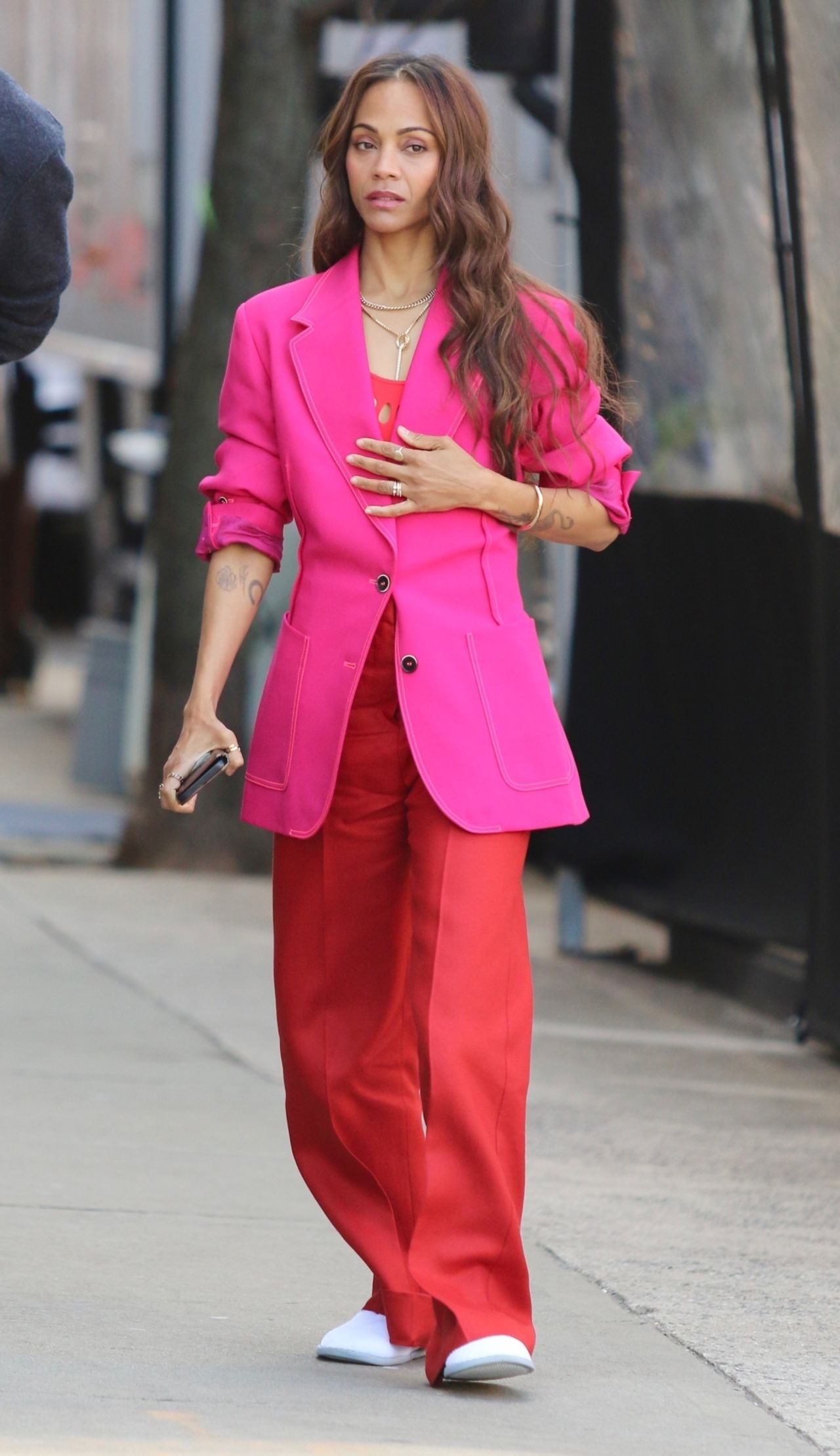 Zoe Saldana In A Colorful Pink And Red Outfit Filming A Stella Artois Beer Commercial In New York