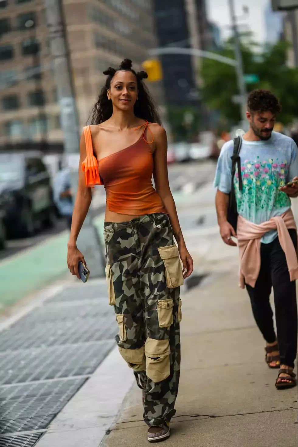 An Asymmetrical Orange Top With Camo Cargos