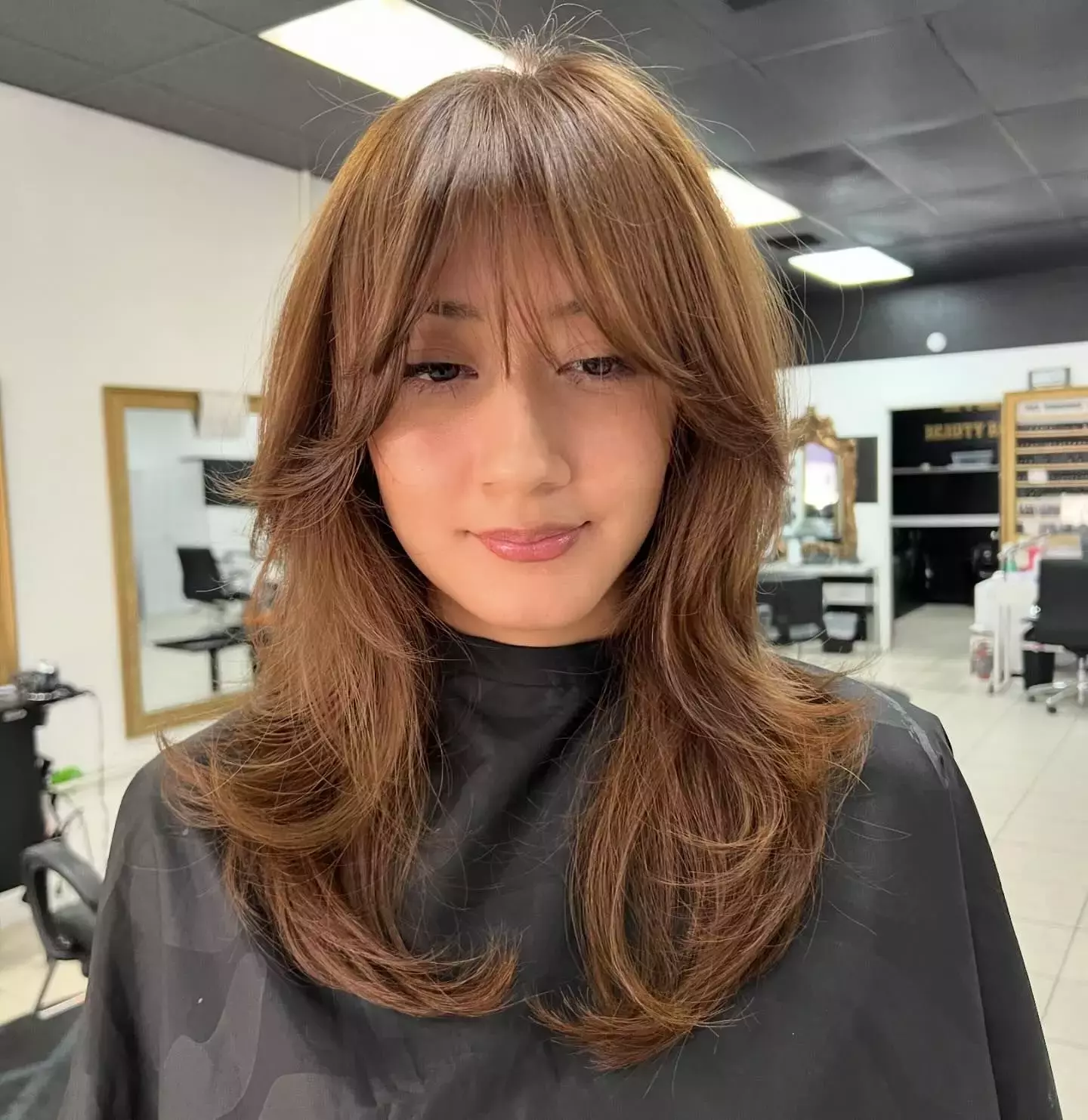 Layered Light Brown Hair With Curtain Bangs